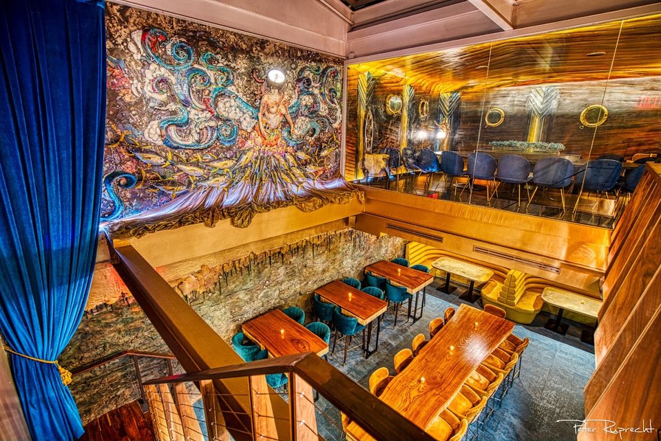 Seafood dishes on ice with nautical decor behind them.