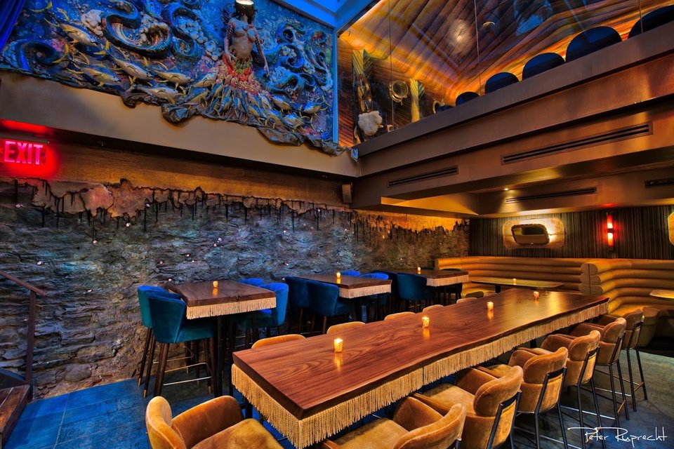 Bright dining room with ocean-themed accents and bar seating.